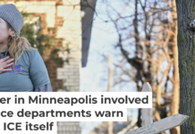 A protester stands near a makeshift memorial honoring Renee Nicole Good, the victim of a fatal shooting in Minneapolis involving federal law enforcement agents. AP Photo/Tom Baker